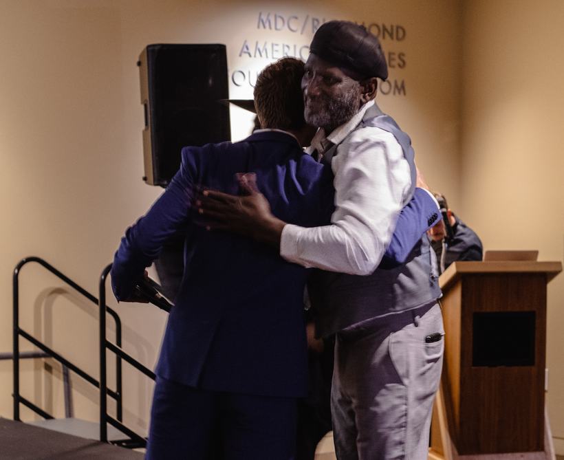 Genn Dickerson of Genna Rae's Wings honored on stage at the 2023 Underdog Family gala