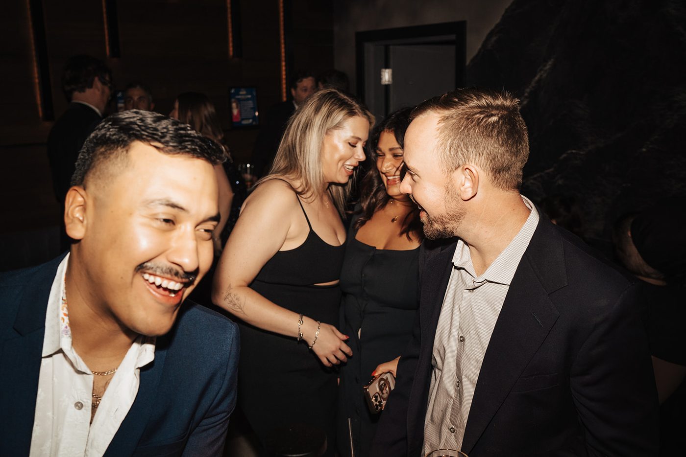 Guests mingling and laughing at the gala