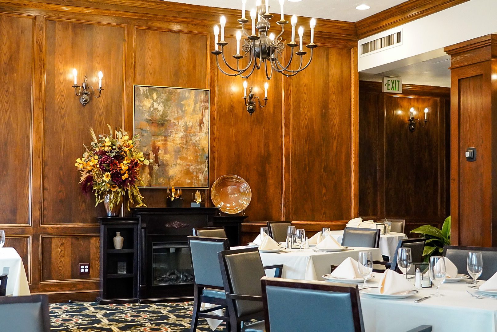 The Centennial Room at the Denver Athletic Club, with chandeliers and wood-paneled walls